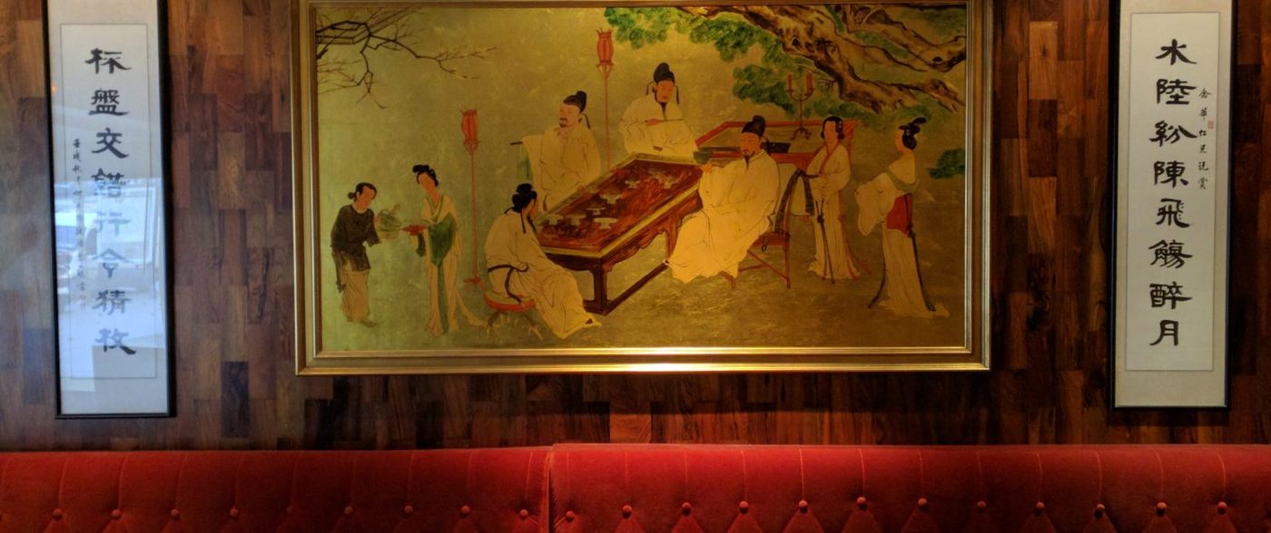 La salle du Diamant Rose : banquette rouge sous une grande peinture chinoise encadrée et deux calligraphies