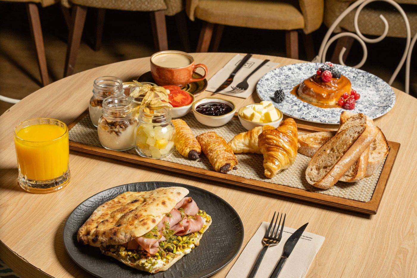 Le plateau du menu brunch de Perrachica : jus d'orange, yaourts, tartines, œufs et charcuterie